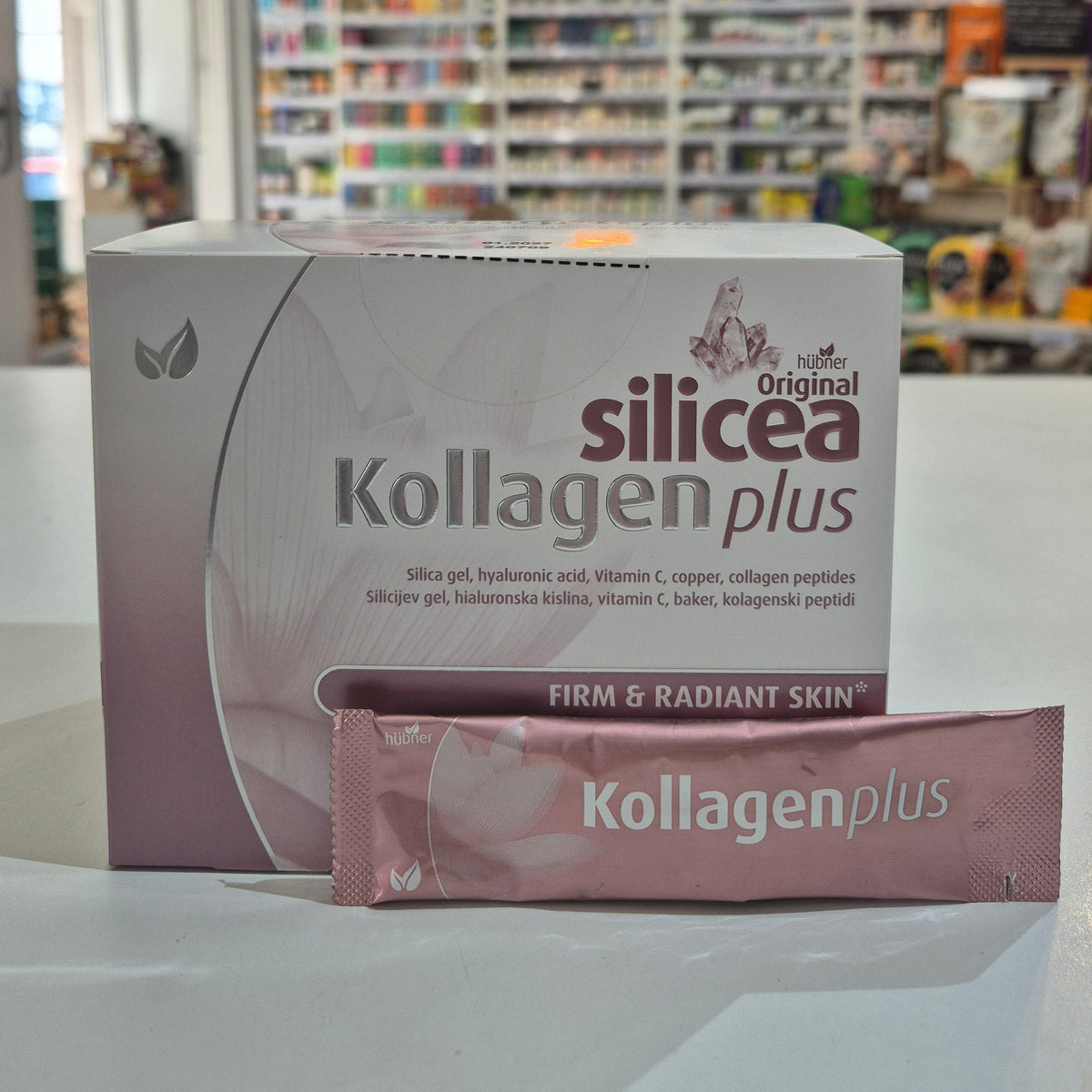 Kollagen Plus packaging on a table with a blurred store background