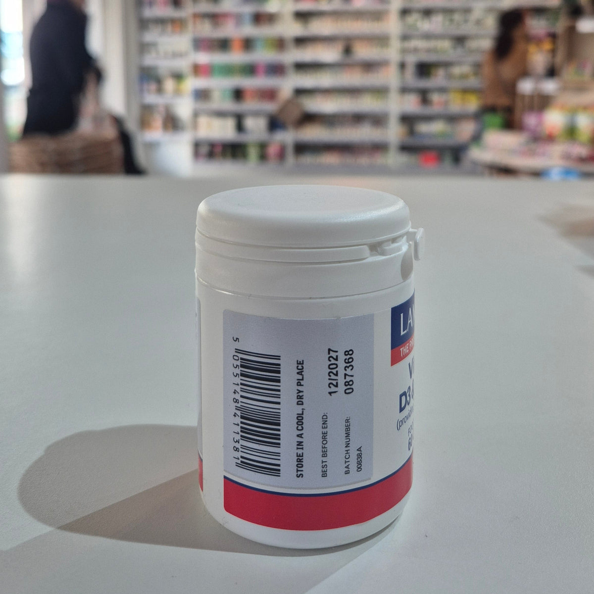 White container with a label on a table in a store setting