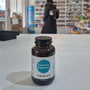Bottle of Viridian supplements on a white surface with a blurred background