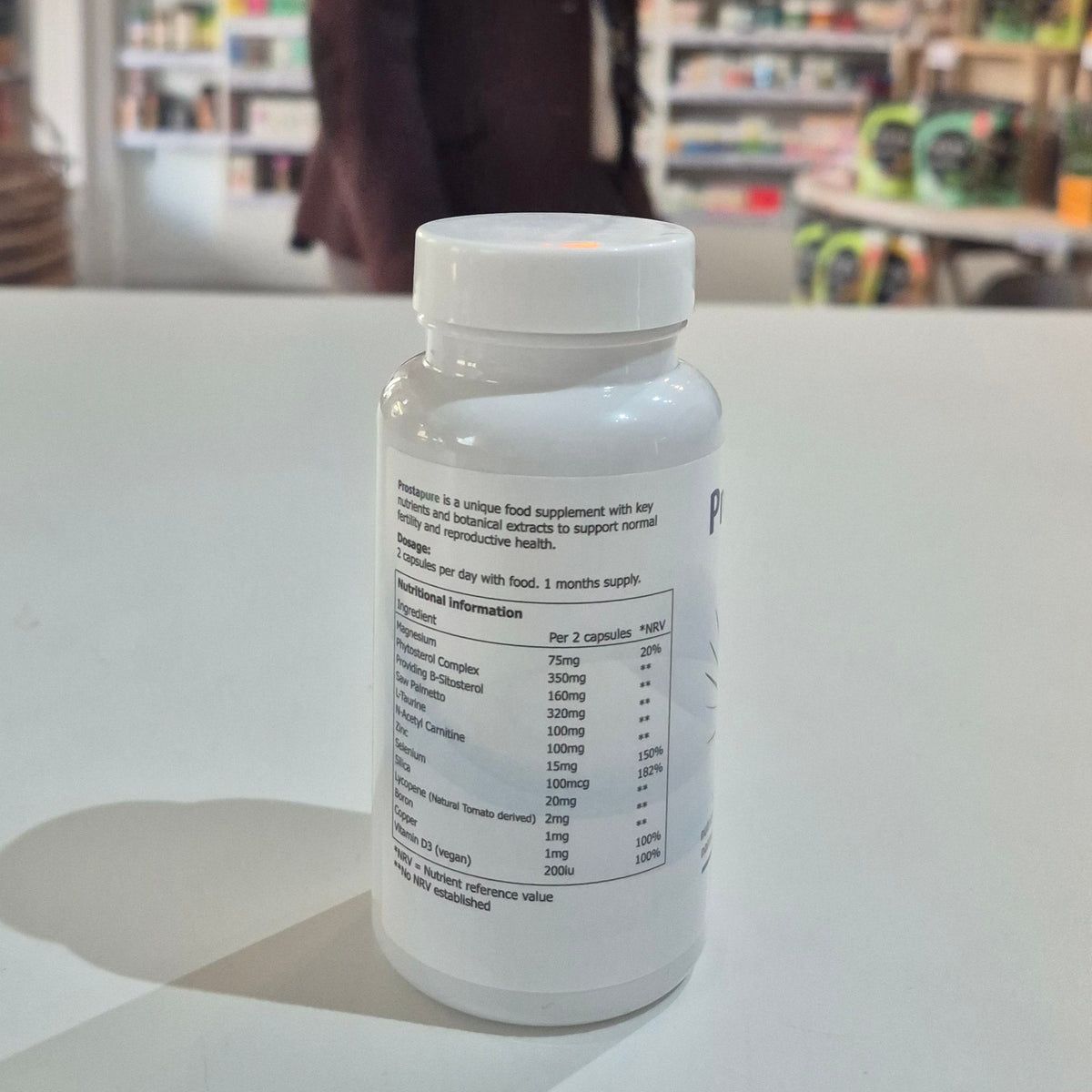 Supplement bottle with nutritional information label on a white surface in a store setting