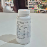 Supplement bottle with nutritional information label on a white surface in a store setting