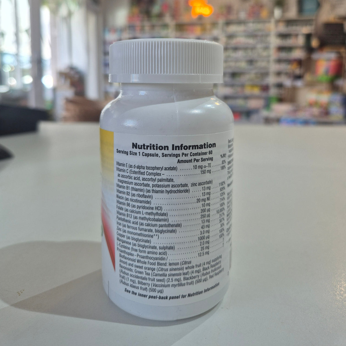 Supplement bottle with nutrition information label on a blurred store background
