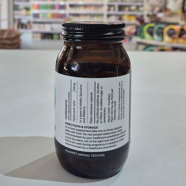 Bottle with label on a white surface with a blurred background