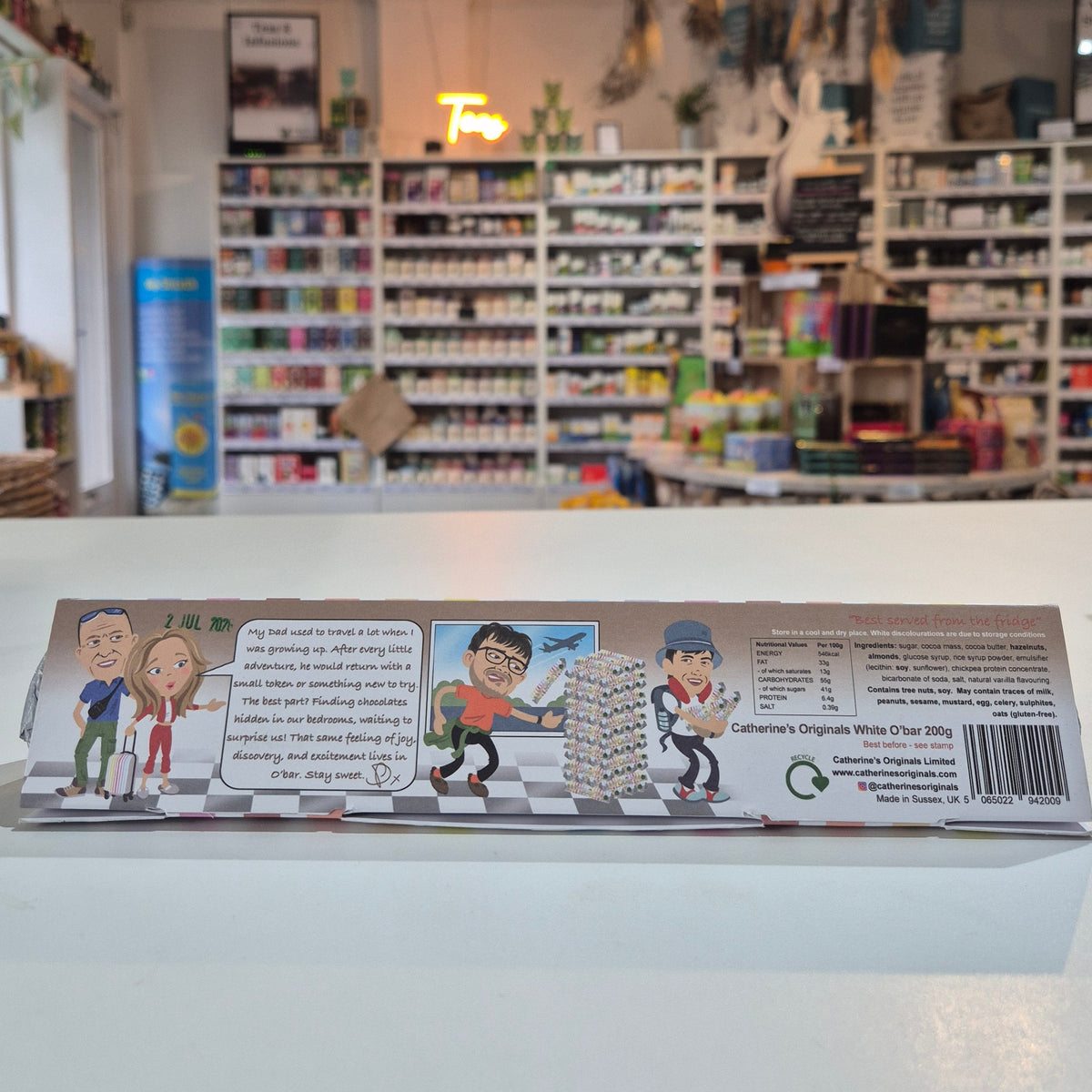 Product packaging with comic-style illustrations on a white wall.