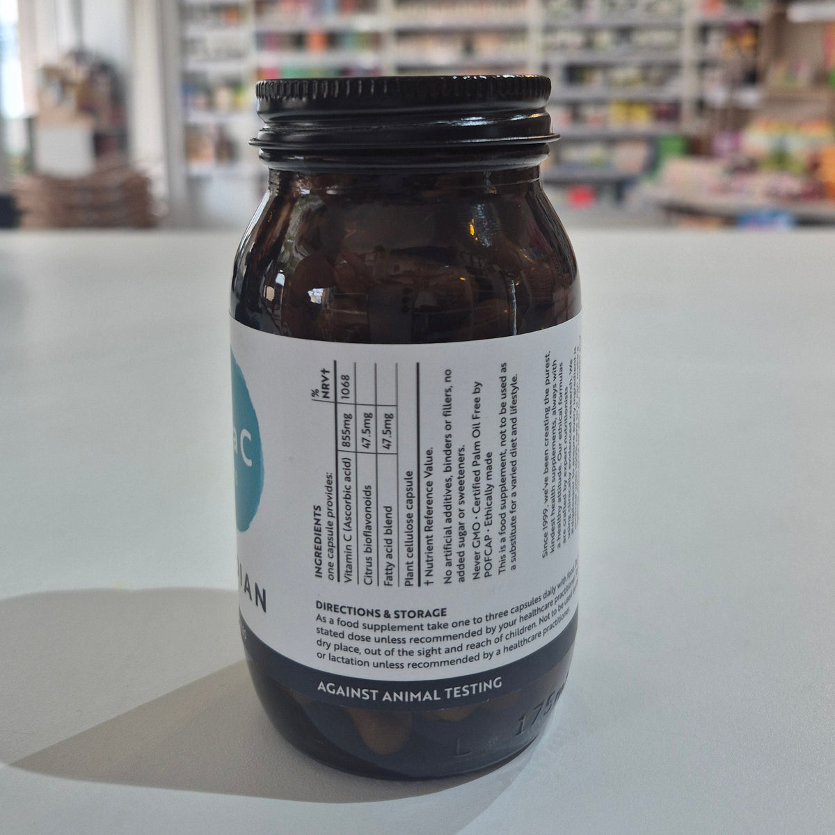 Bottle of Viridian Extra C supplement on a white surface with a blurred background.