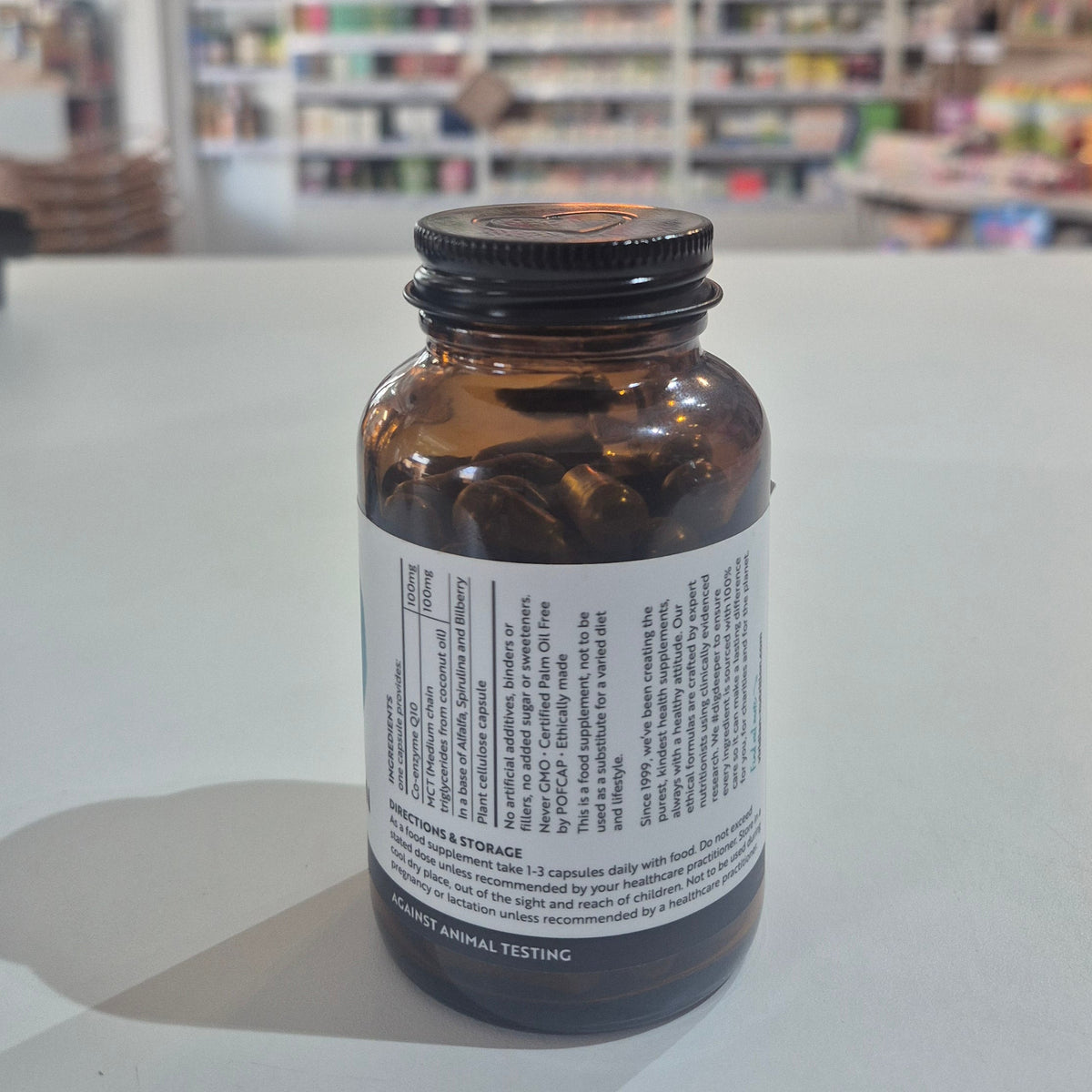 Bottle of Viridian Co-Q10 & MCT supplement on a shelf with a blurred store background