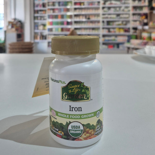 A bottle of Nature's Plus Source of Life Garden Iron, certified organic iron whole food grown, with the USDA organic seal displayed in a store setting