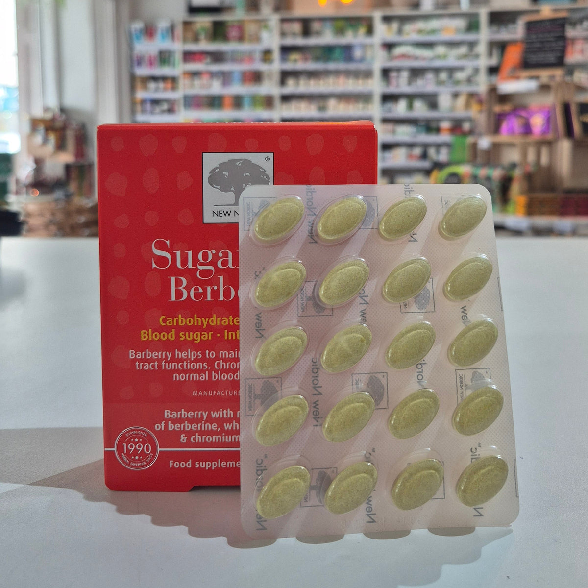 Packaging of Sugarcut Berberine with green capsules against a blurred store background