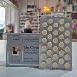Pack of white capsules with a blurred store interior in the background