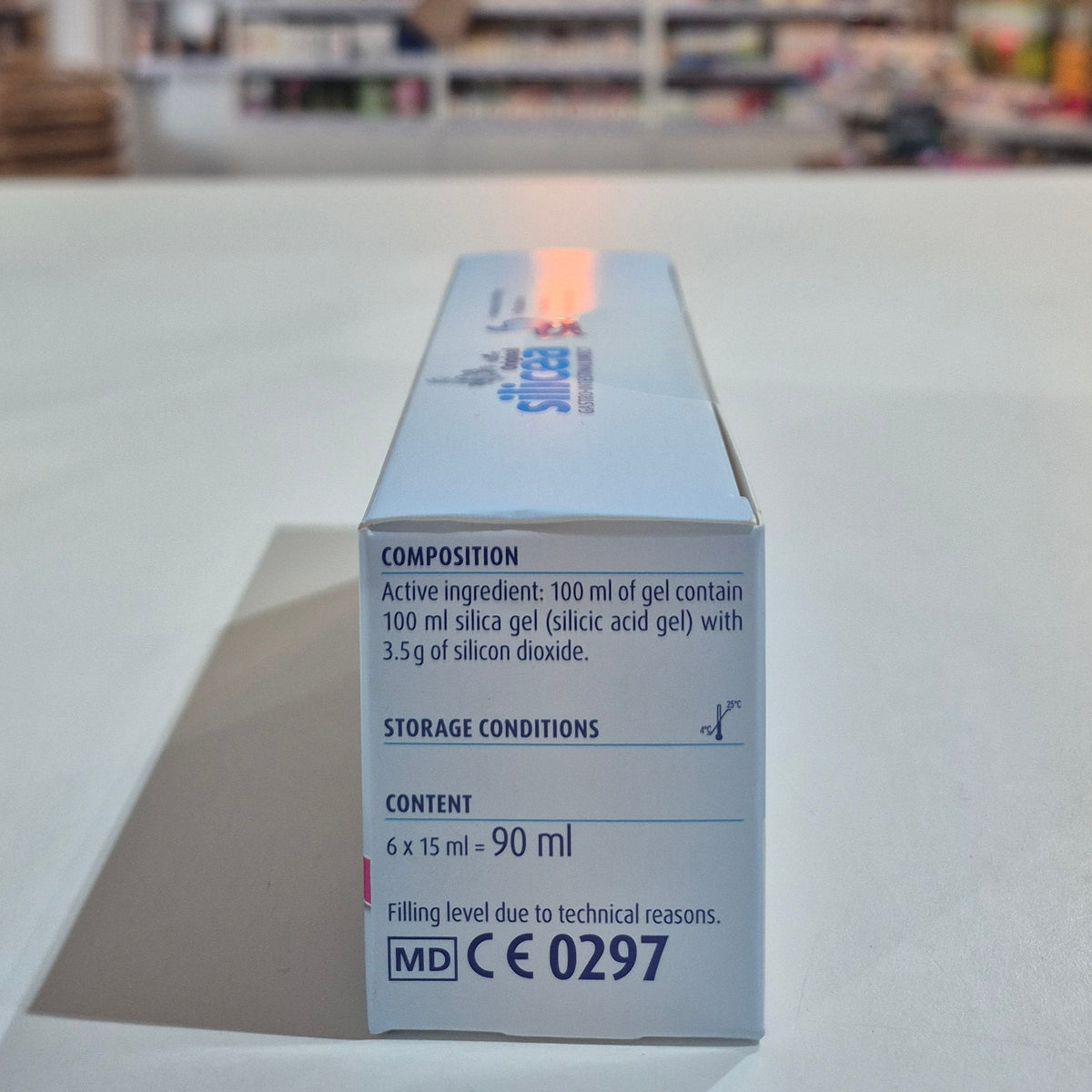 Box of silicea Gastrointestinal Direct on a counter with a blurred store background. Box with medical or scientific information on a blurred background
