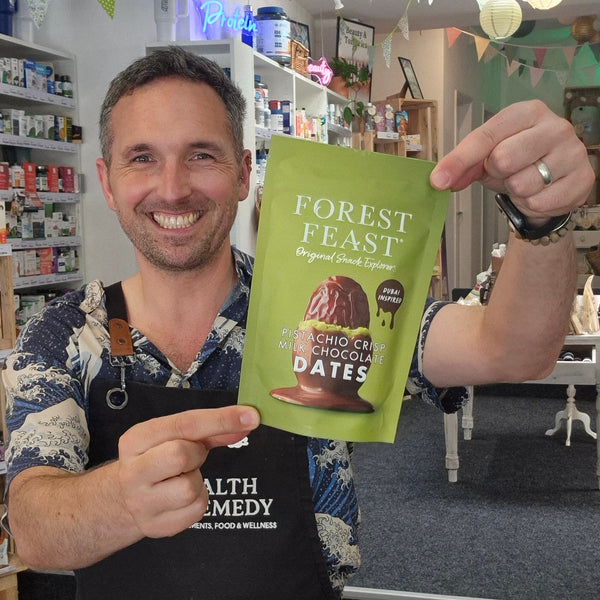Man holding a 'Forest Feast' product package in a store setting