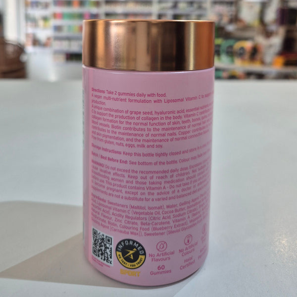 Pink supplement bottle with copper cap on a white surface