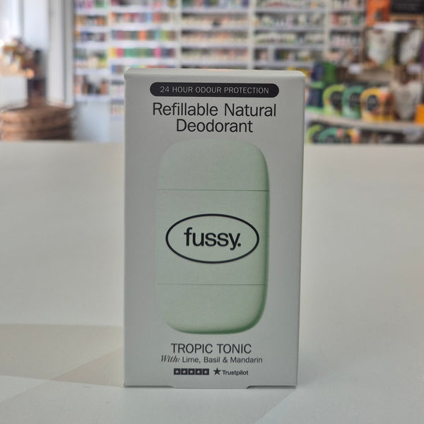 Box of fussy refillable natural deodorant on a white surface with a blurred background