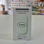 Box of fussy refillable natural deodorant on a white surface with a blurred background