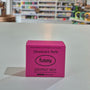 Pink deodorant refill box labeled 'fussy' on a counter with a store background.