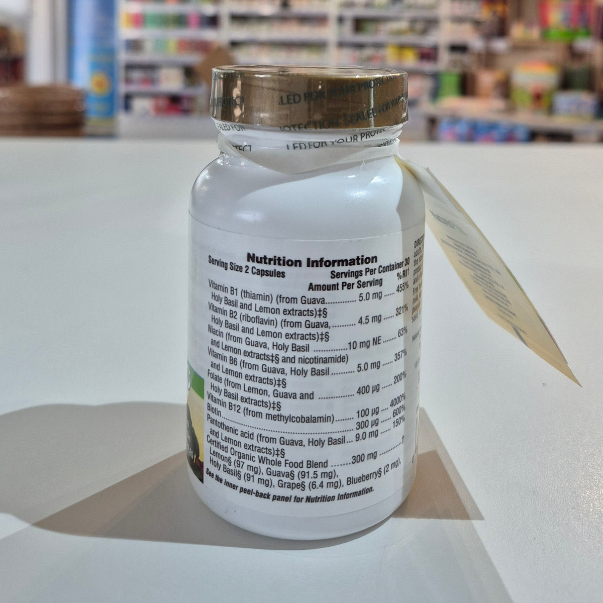 Supplement bottle with nutrition information label on a table in a store setting