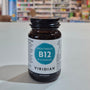 Bottle of Viridian High Twelve B12 B-Complex supplement on a table with a blurred store background.