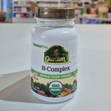 Nature's Plus B-Complex supplement bottle on a white surface with blurred store background