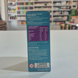 Blue box with nutritional information and warning label on a white surface with a blurred store background