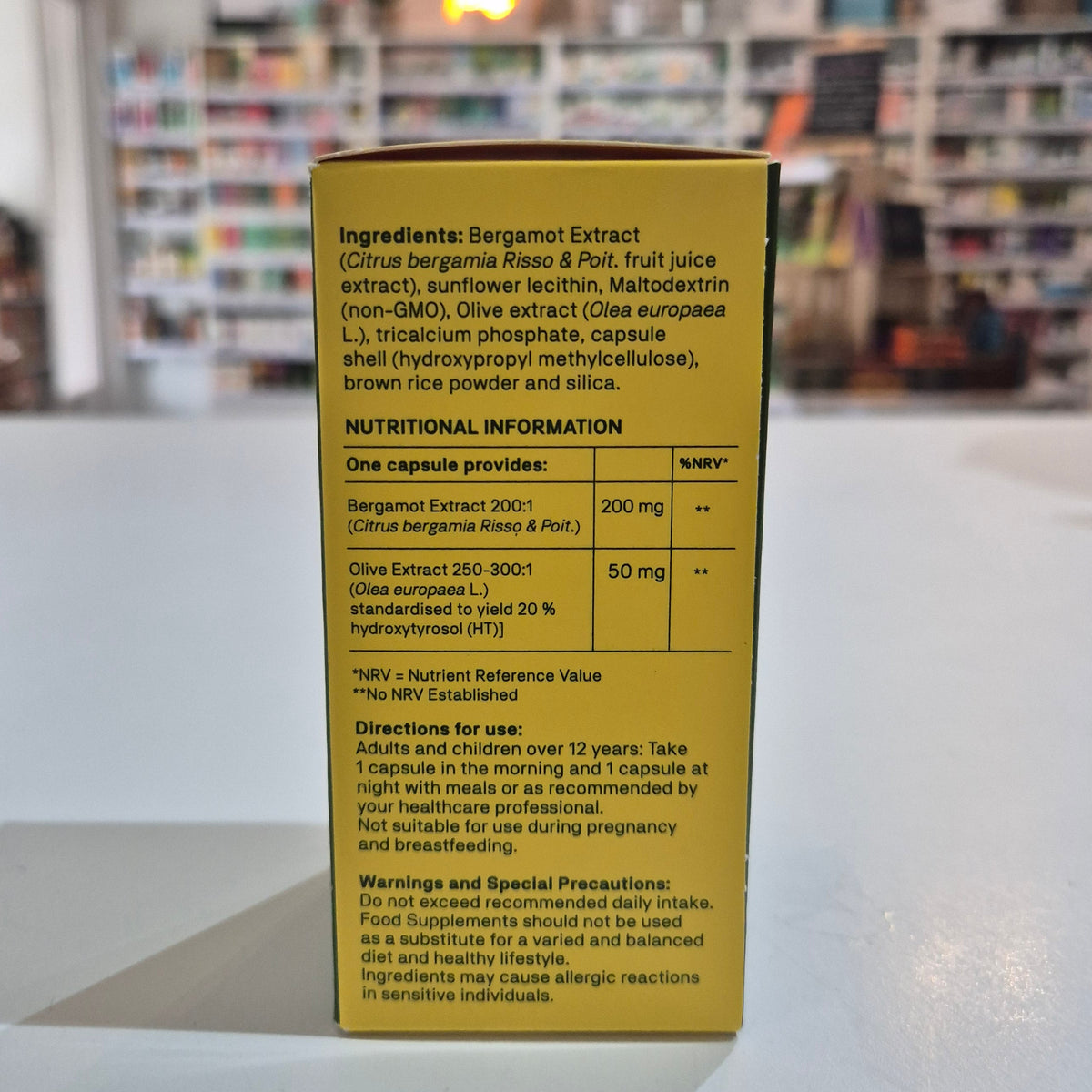 Yellow box with text on a white surface with a blurred background
