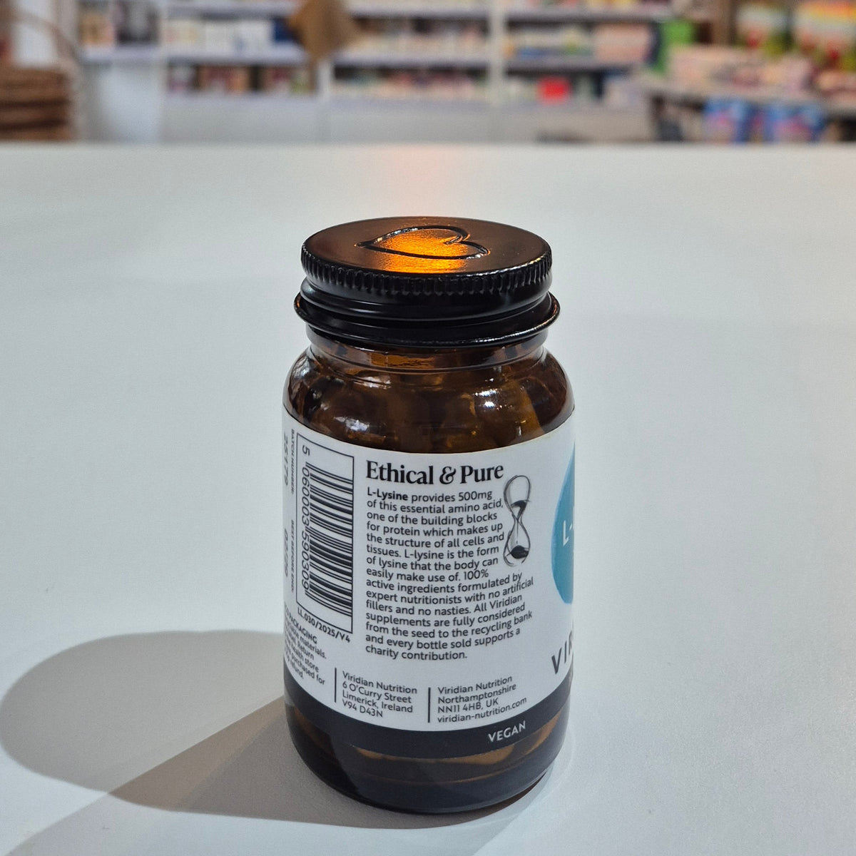 Bottle cap with visible label against a blurred indoor background