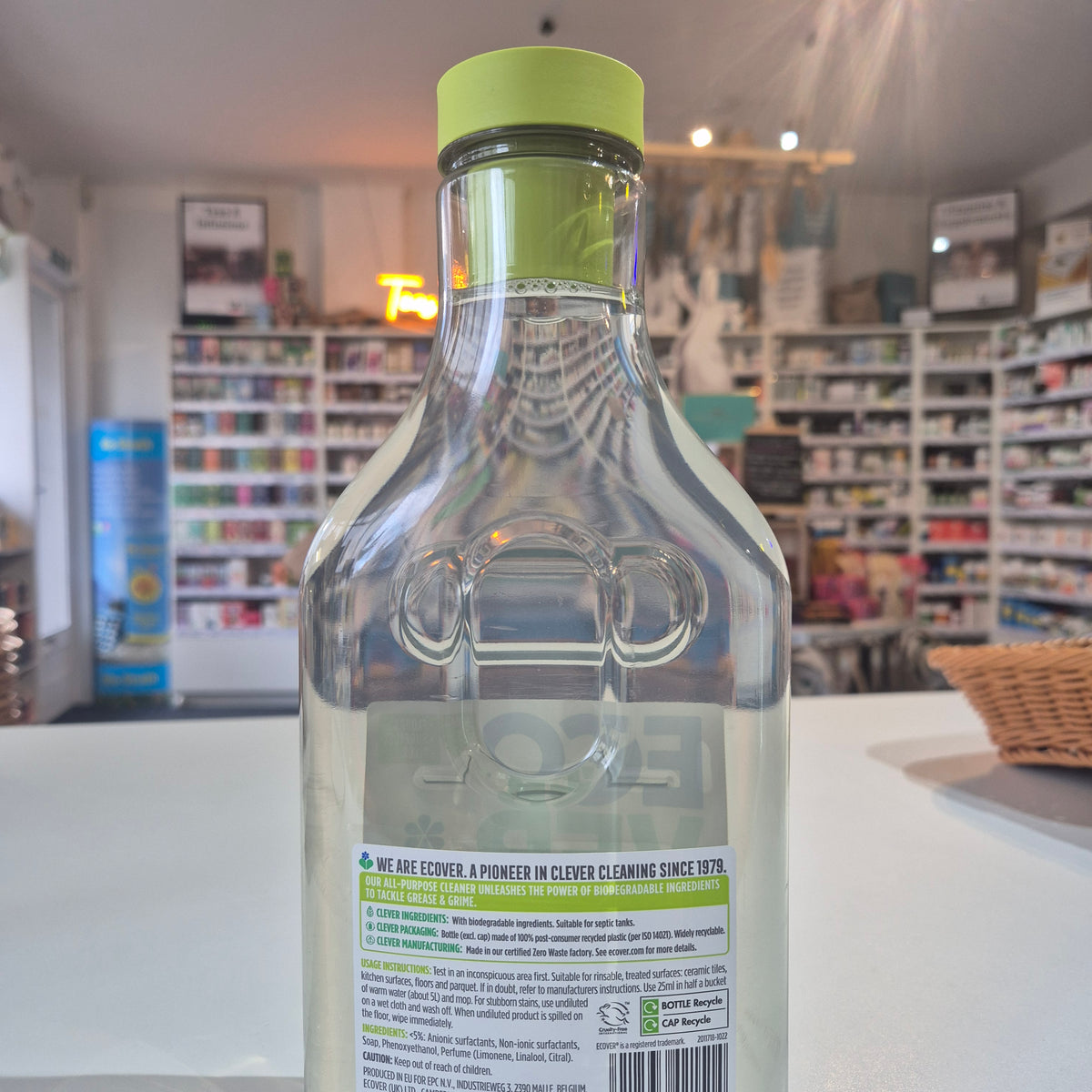 Bottle with a green cap and label in a store setting
