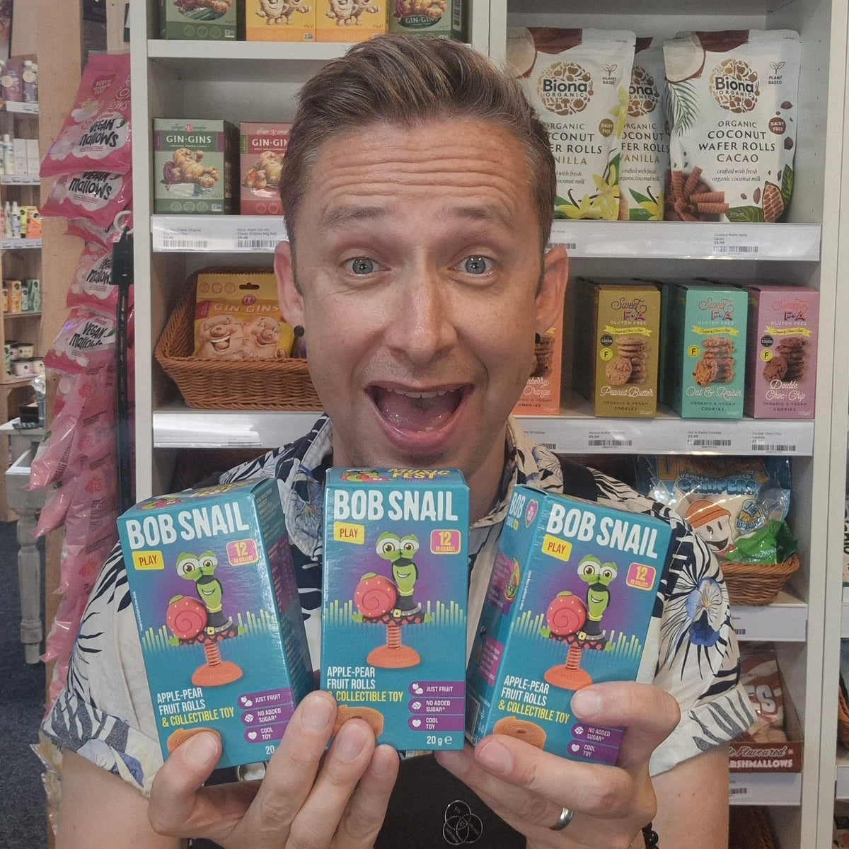 Person holding Bob Snail products in a store setting