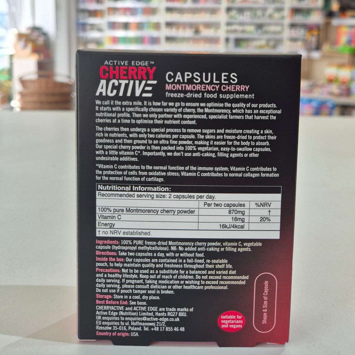 Close-up of a supplement capsule container with text on a blurred background