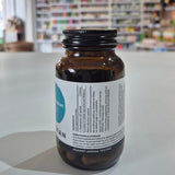 Brown bottle with a label on a white surface, blurred store interior in the background