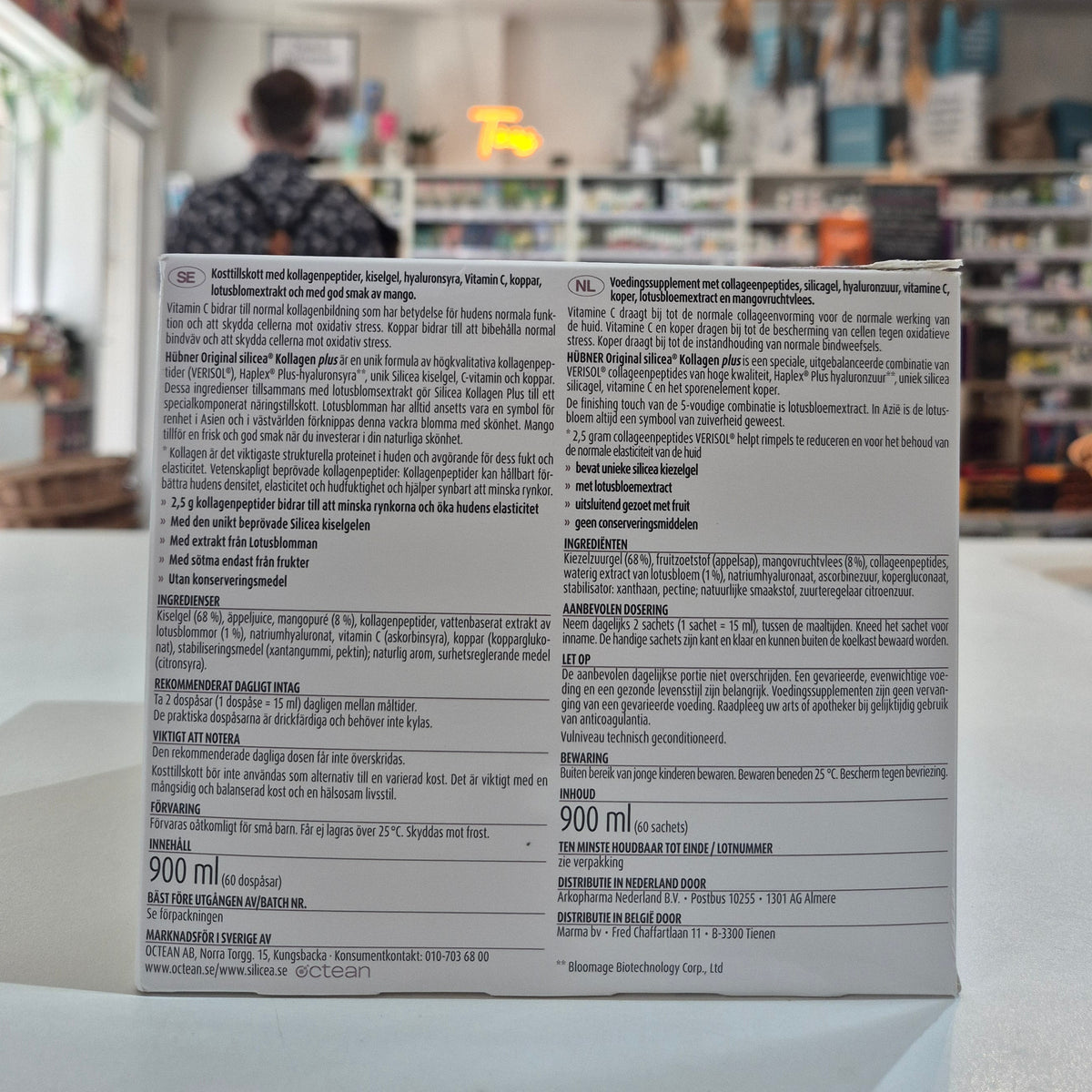 Product packaging with text and a blurred indoor background