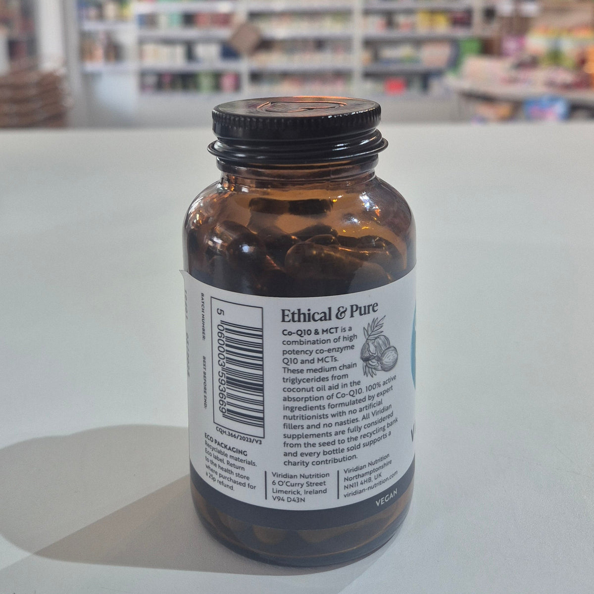 Bottle of Viridian Co-Q10 & MCT supplement on a shelf with a blurred store background
