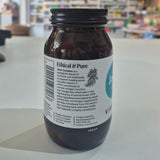 Bottle of 'Ethical & Pure' Viridian supplement with a label on a blurred store background