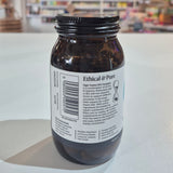 Jar of Viridian High Twelve B12 B Complex supplement on a white surface with a blurred store background.. Brown supplement jar with 'Ethical & Pure' label on a white surface