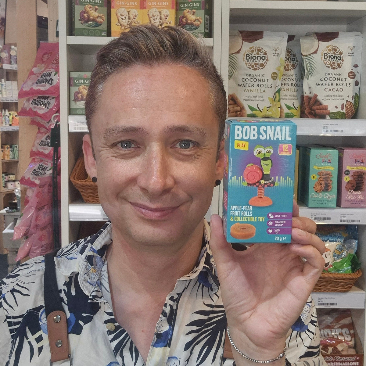 Person holding a 'Bob Snail' product in a store setting