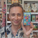 Person holding a 'Bob Snail' product in a store setting