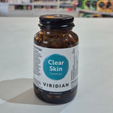 Brown supplement bottle labeled 'Clear Skin Complex' by Viridian on a white surface.