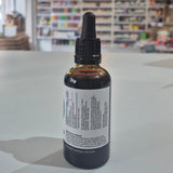 Bottle of Viridian Liquid B12 on a table with a blurred store background. Bottle with dropper on a table in a store setting
