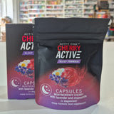 Two packages of 'Active Cherry Active' capsules on a white surface with a blurred background.