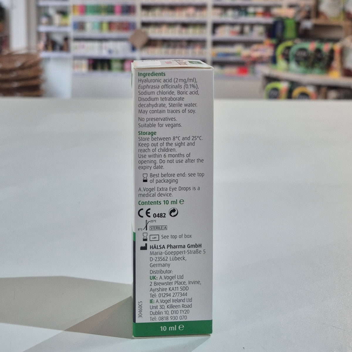 Box of eye drops with ingredients list on a table in a store setting