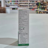 Box of eye drops with ingredients list on a table in a store setting