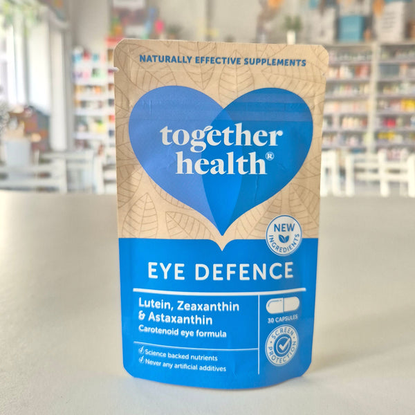 Supplement bottle labeled 'Together Health Eye Defence' on a blurred background