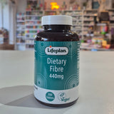 Lifeplan Dietary Fibre 440mg supplement bottle on a counter with a store background