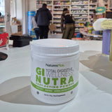 Container of 'Wellness Nutra' product with a store interior in the background