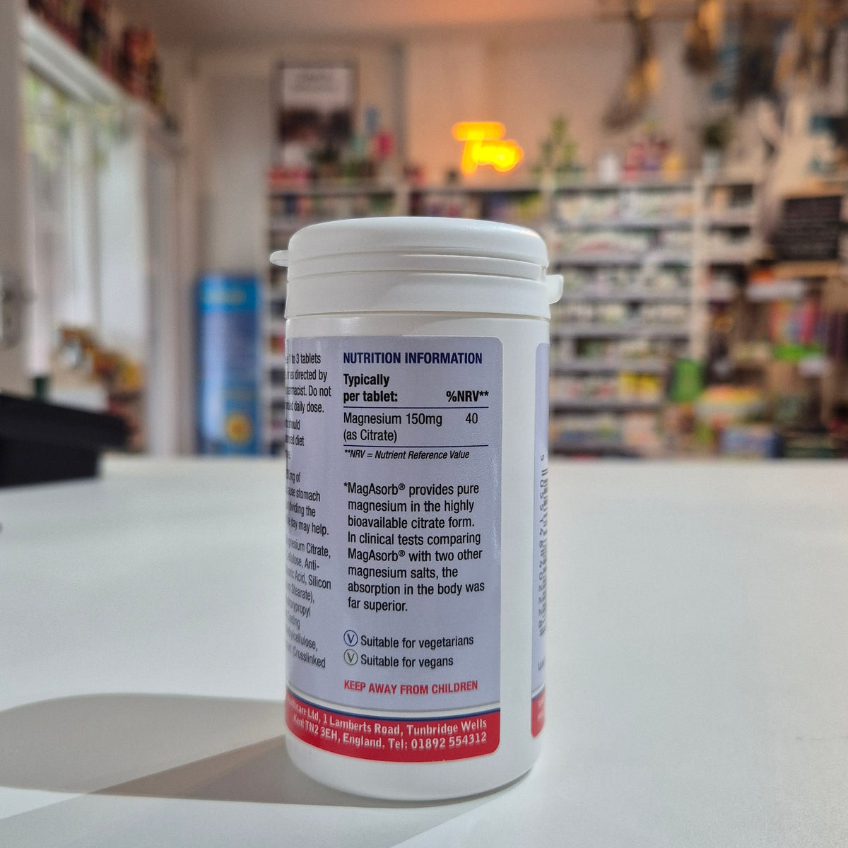Supplement container with nutritional information label on a counter in a store setting