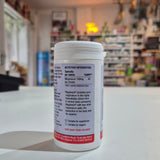 Supplement container with nutritional information label on a counter in a store setting