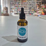 Bottle of Viridian Vitamin D3 & K2 Liquid on a table with a blurred store background