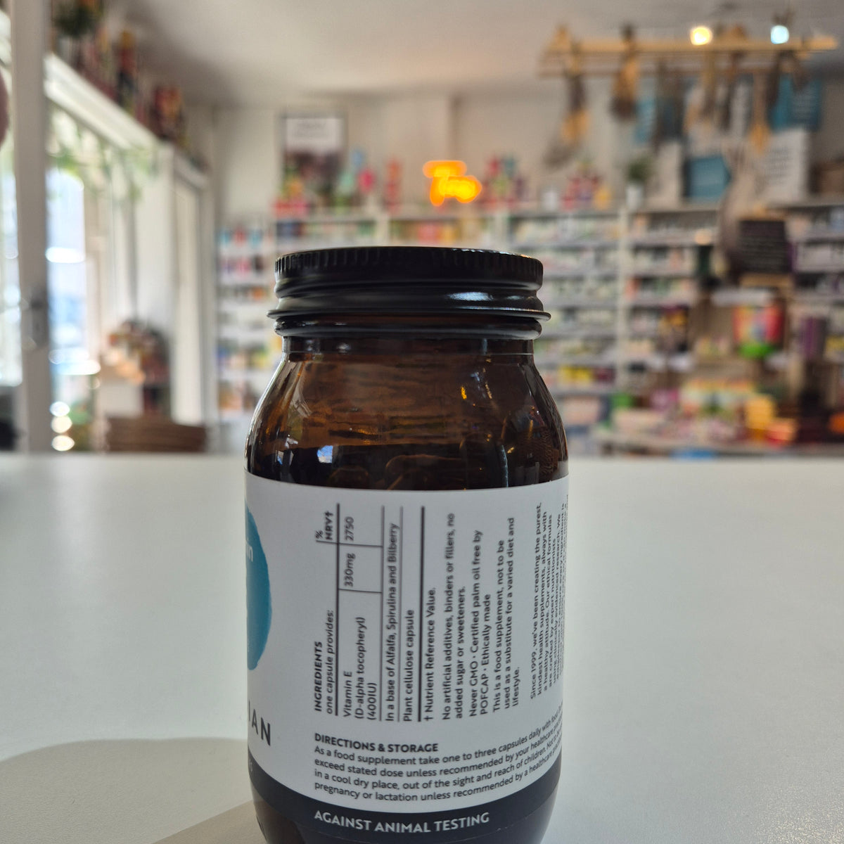 Bottle with a label on a white surface, blurred background
