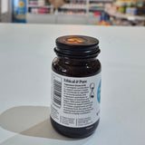 Bottle cap with label on a white surface, blurred background of shelves with products