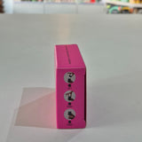 Pink box with instructions on a gray surface