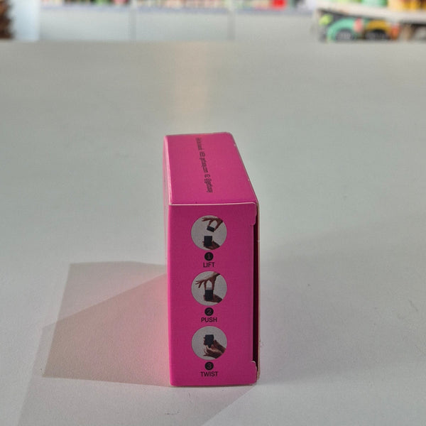 Pink box with instructions on a gray surface
